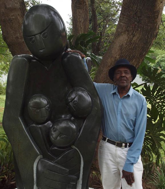 Edward Chiwawa with his sculpture 'Protective Mother'