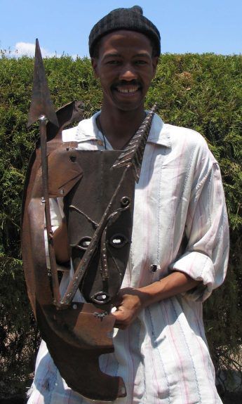 Welded scrap metal mask sculpture - 'Thought I Was Protected' by African artist Danisile Ncube from Zimbabwe
