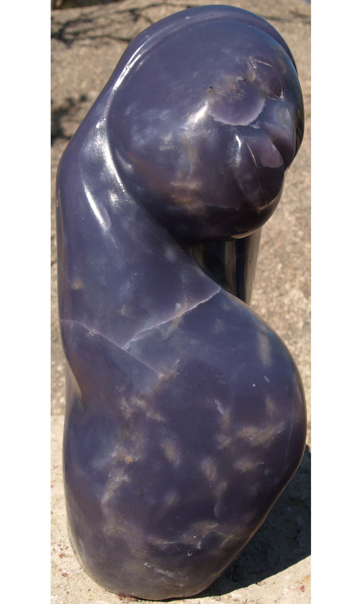 Purple stone lepidolite sculpture Paying Attention by Zimbabwean artist Sylvester Mubayi - left side
