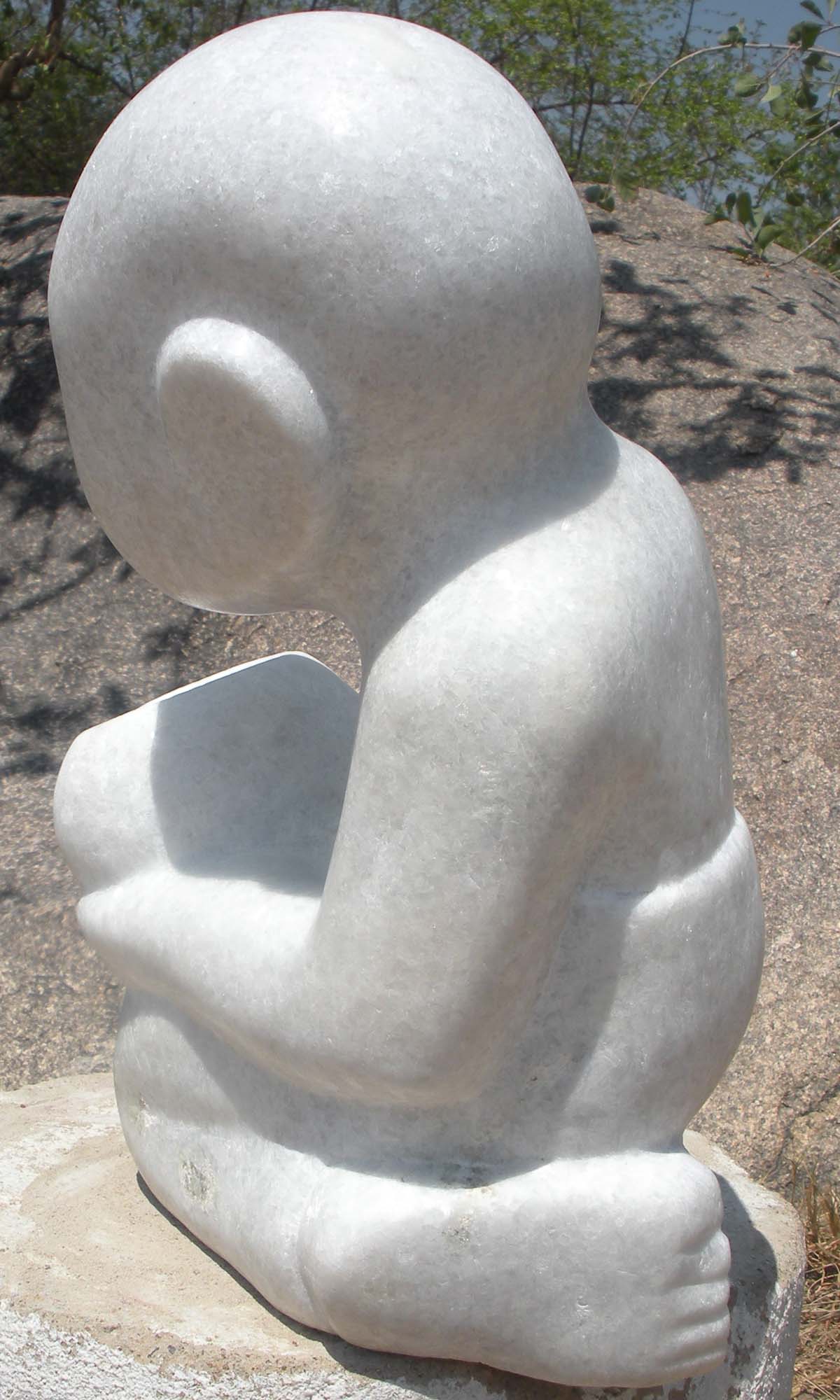 White marble Shona sculpture 'Bring You Some Food' by artist Sylvester Mubayi - back left