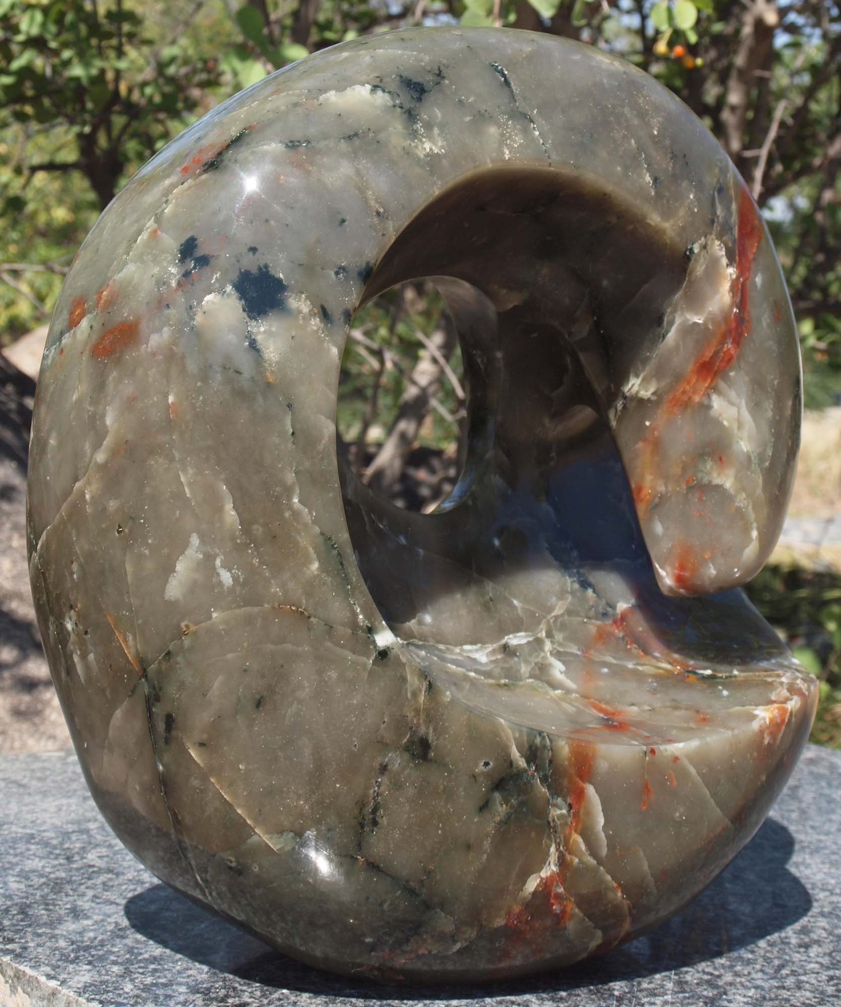 Colourful abstract stone sculpture - 'World In My Hands' by Tanyanyiwa Nyandoro - front left
