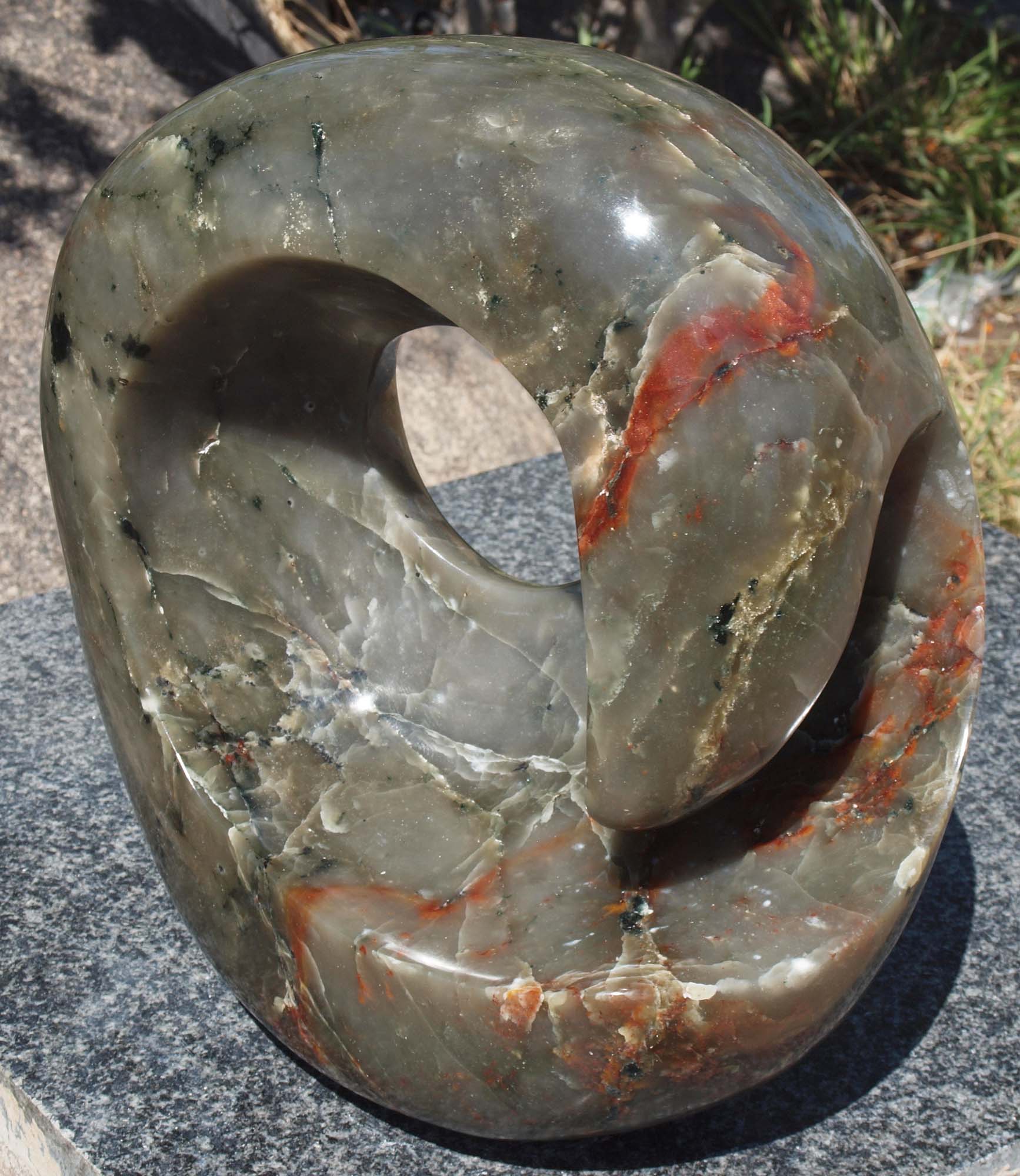 Colourful abstract stone sculpture - 'World In My Hands' by Tanyanyiwa Nyandoro - front right