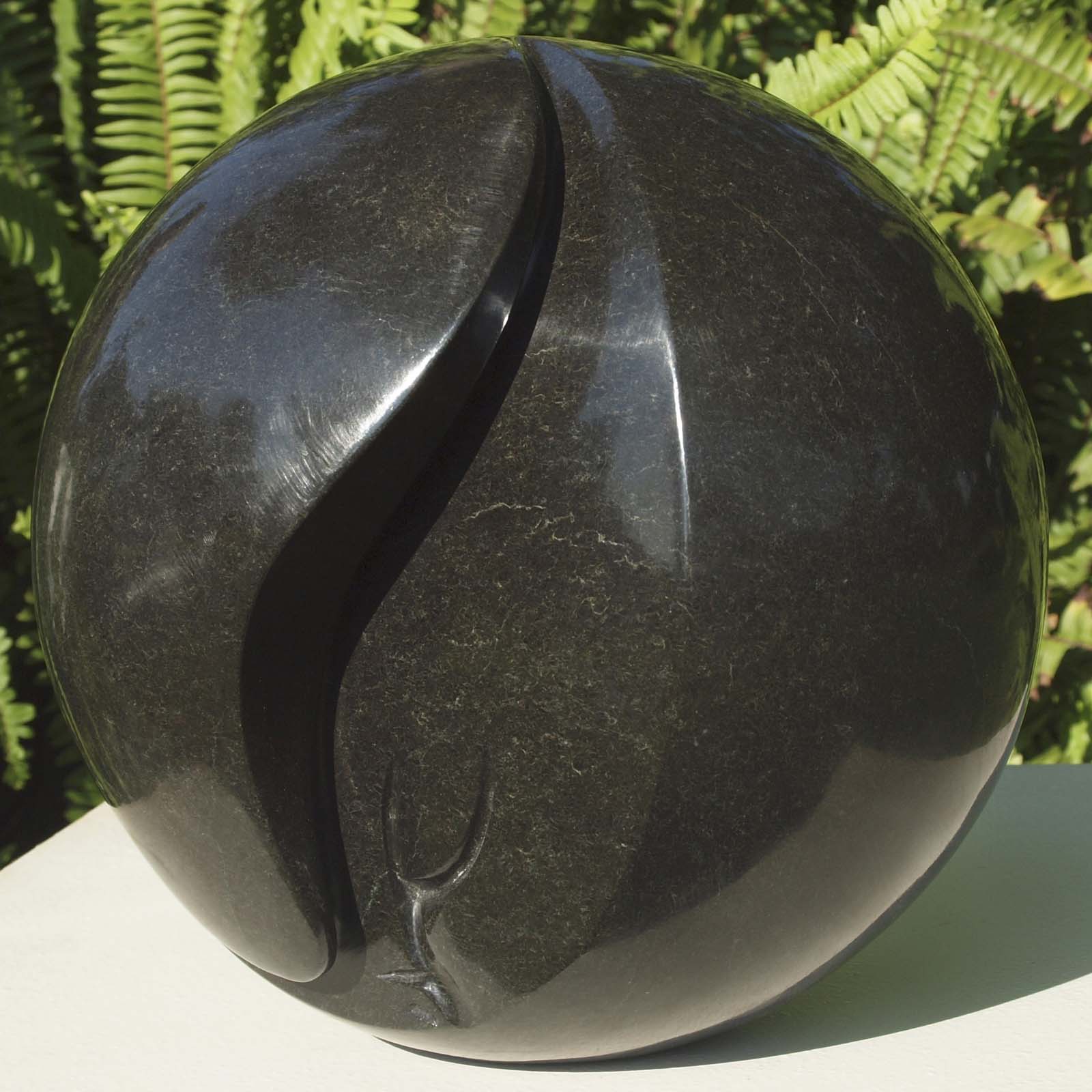 Round head black stone sculpture - 'Hiding My Face' by famous artist Nesbert Mukomberanwa from Zimbabwe - front right