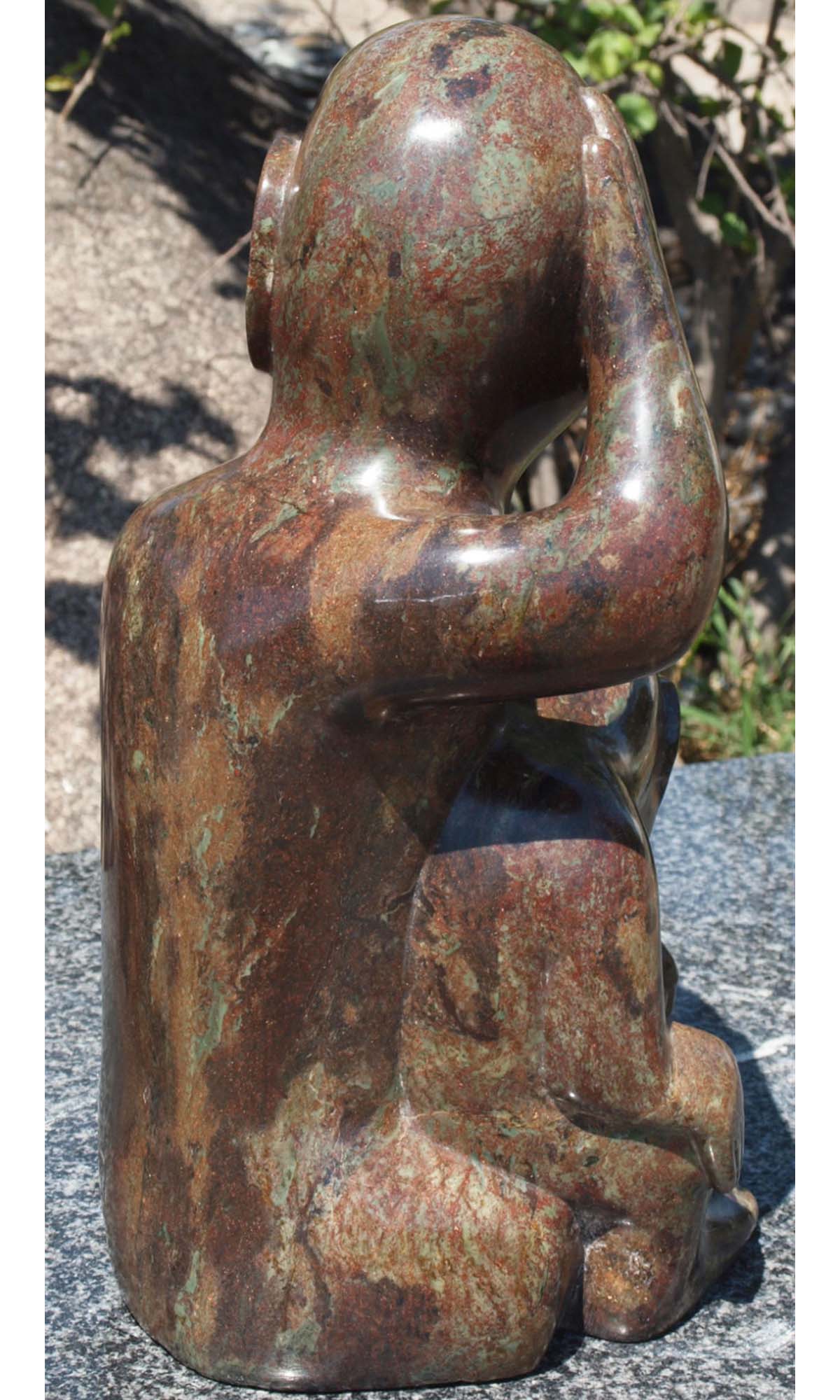 Stone sculpture of children - 'What Shall We Do?' by Sylvester Mubayi - back right