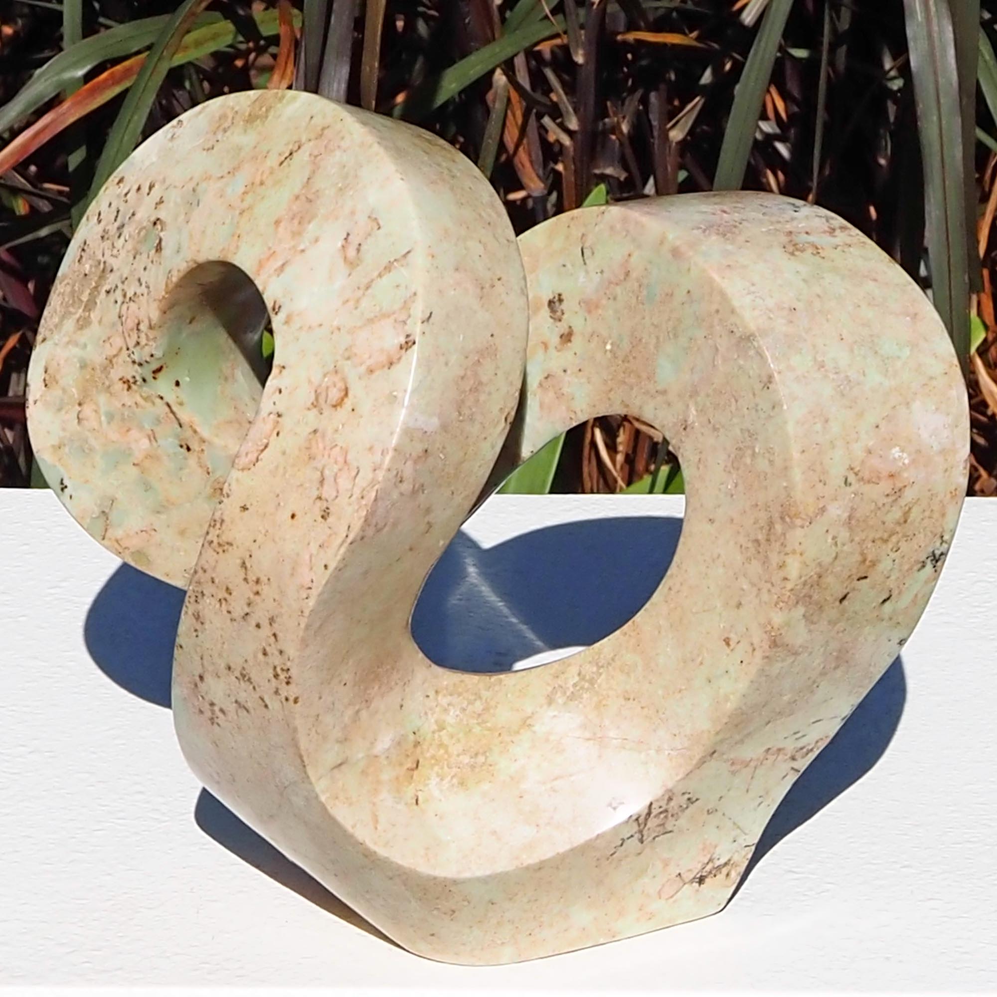 Pink stone stone sculpture original carving - Follow Me by Charles Kowo - front from above
