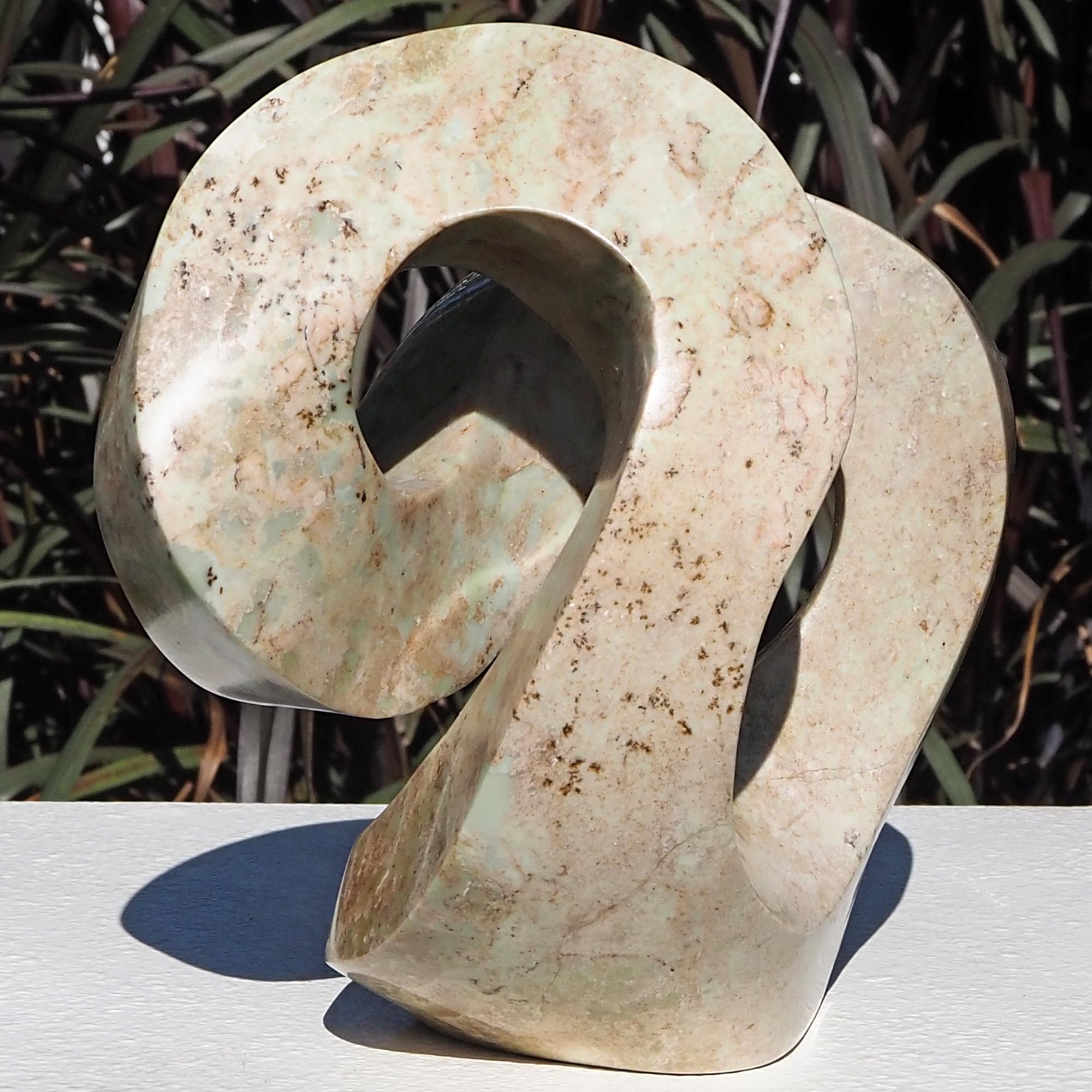 Pink stone stone sculpture original carving - Follow Me by Charles Kowo - front left