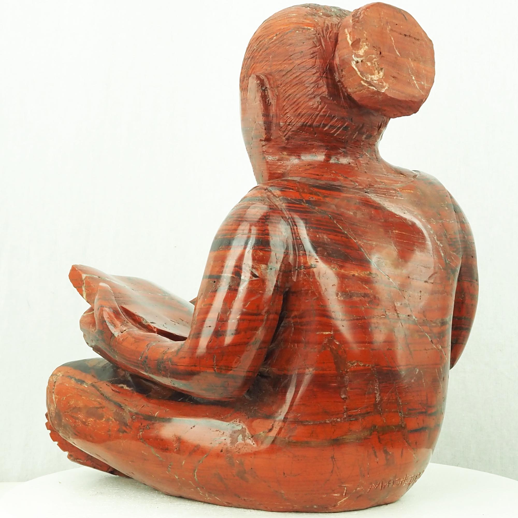 Sculpture child girl reading red stone - Doing My Homework by Jonathan Mhondorohuma - back left