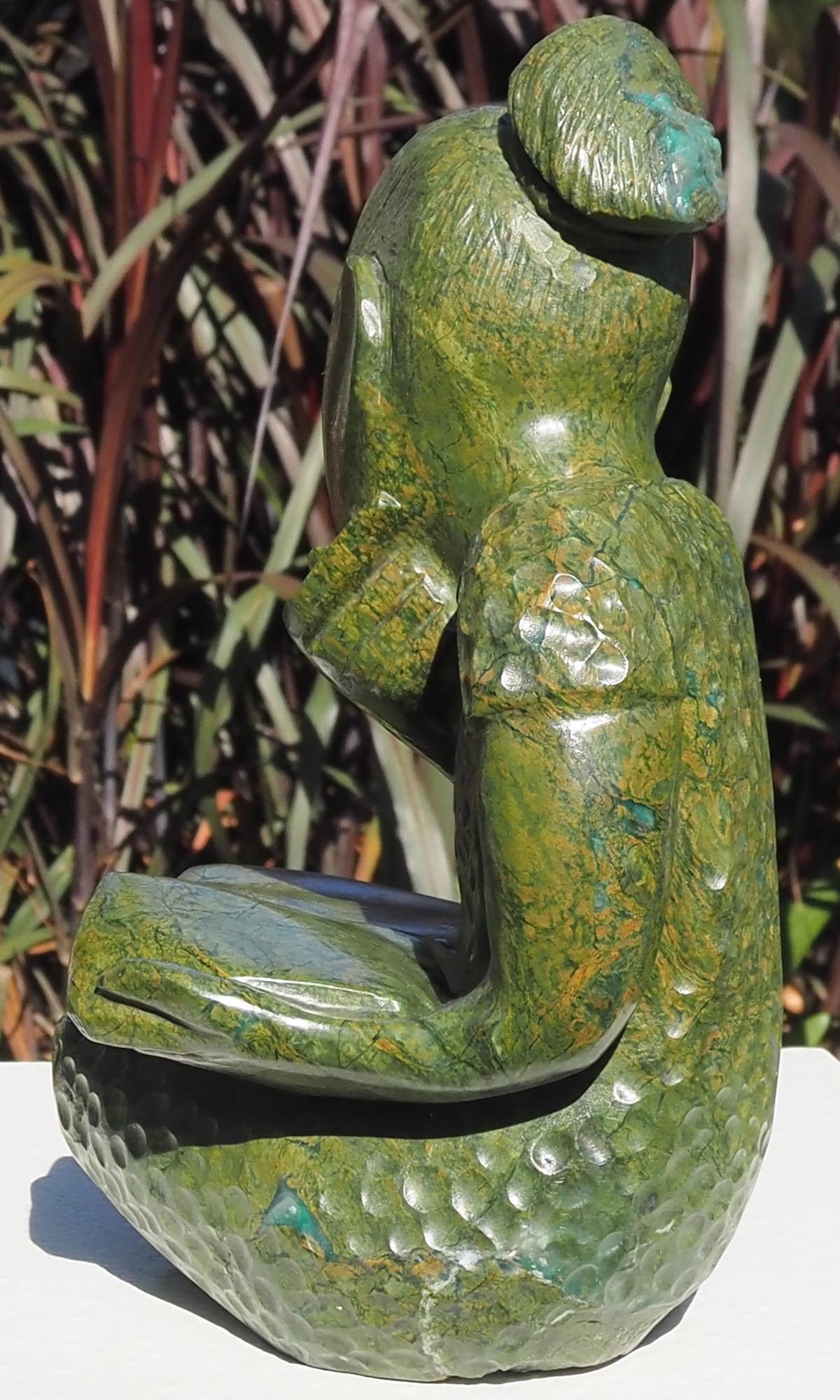 Green stone sculpture child girl book - Joy of Reading by Jonathan Mhondorohuma - back left