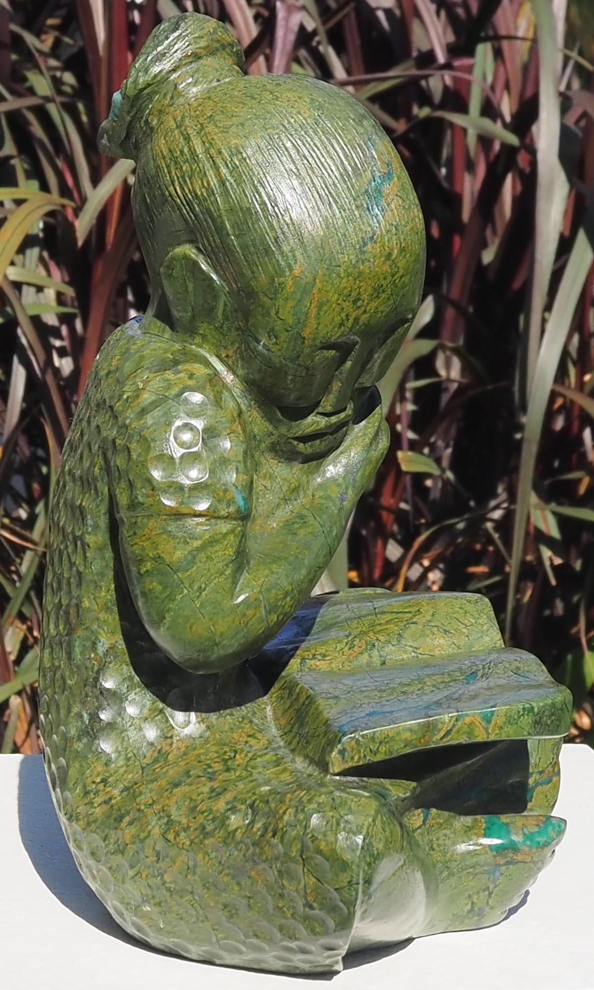 Green stone sculpture child girl book - Joy of Reading by Jonathan Mhondorohuma - front left