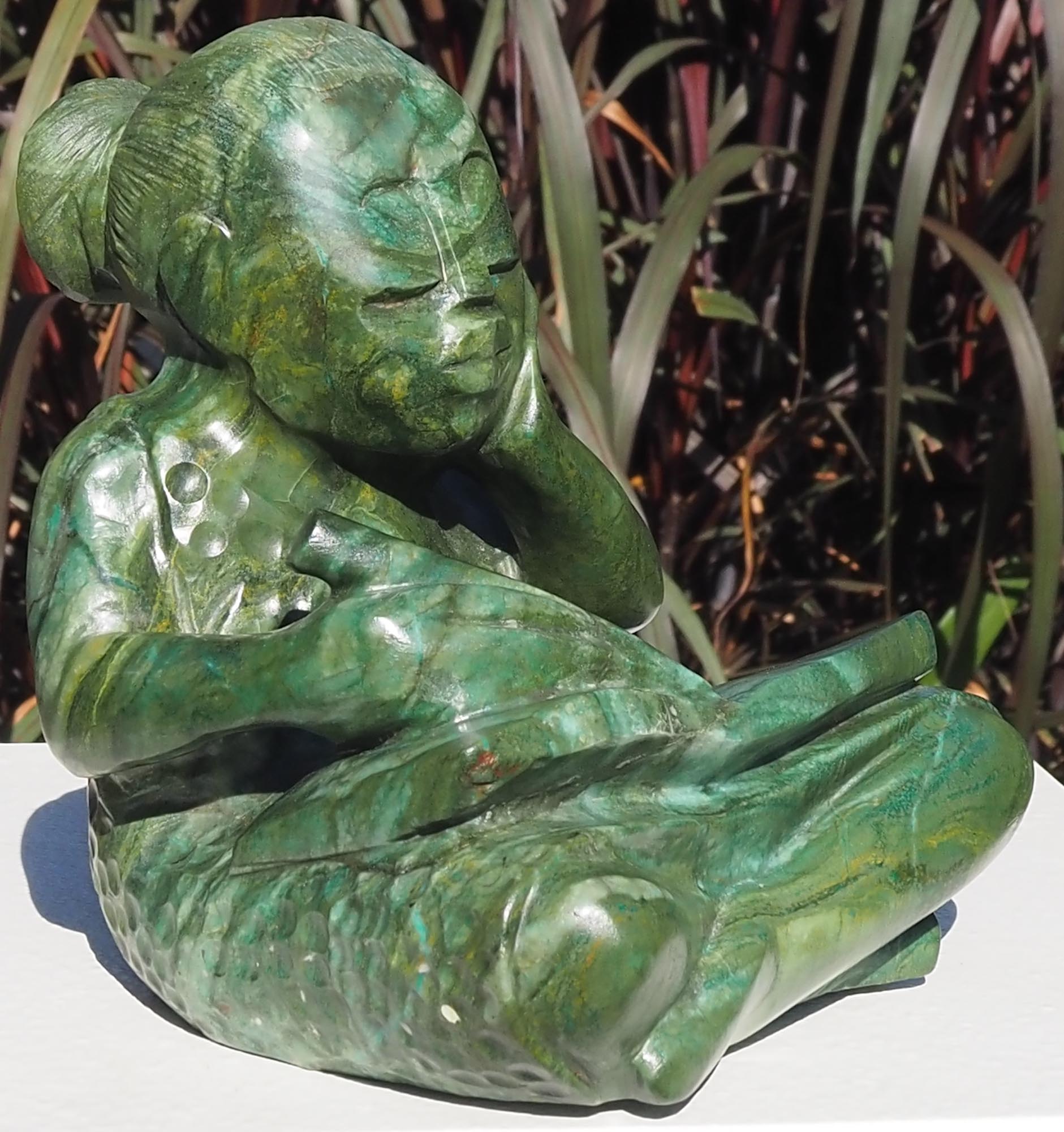 Green stone sculpture child girl book - Writing A Story by Jonathan Mhondorohuma - front left