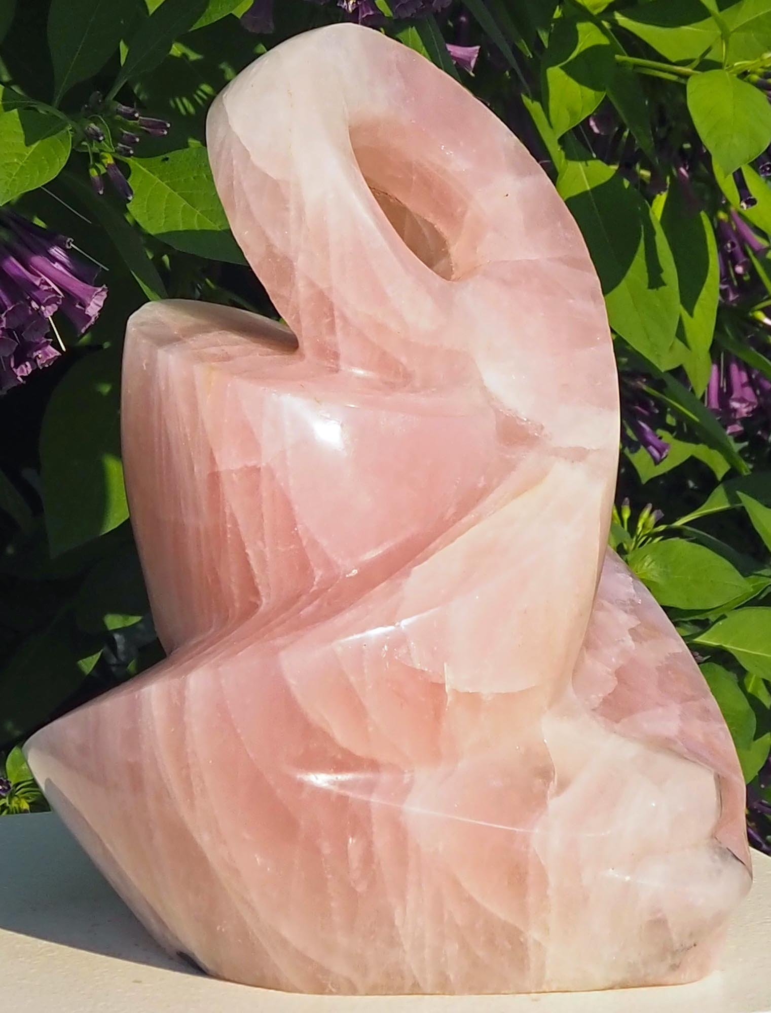 Rose quartz pink stone sculpture art UK - Family Guardian by Tafadzwa Tandi - front left