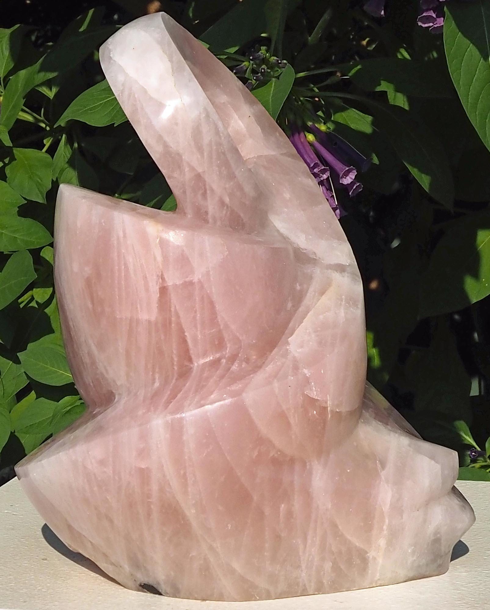Rose quartz pink stone sculpture art UK - Family Guardian by Tafadzwa Tandi - left side