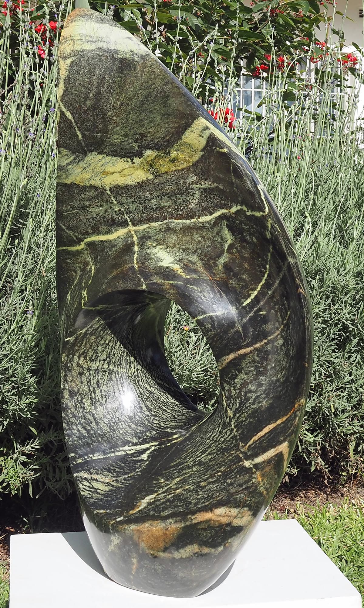 One-off stone garden sculpture centrepiece UK - Healing Herb by Tendai Gwaravaza - front right